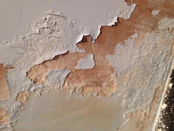 Rising damp damage showing tide marks on interior wall
